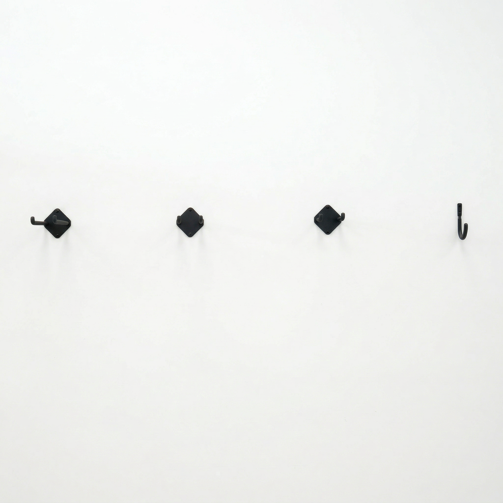 Row of small Simple Hooks on a white wall
