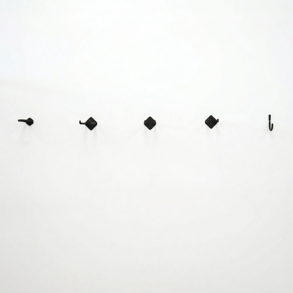 Row of Simple Hooks mounted on a white wall, front view