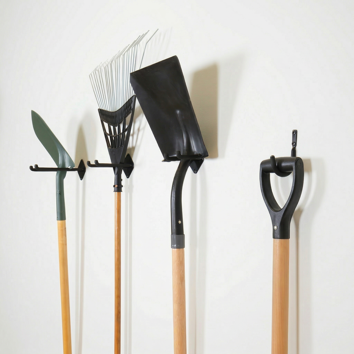 Simple Hooks holding a shovel, rake, spade and other yard tools on a wall