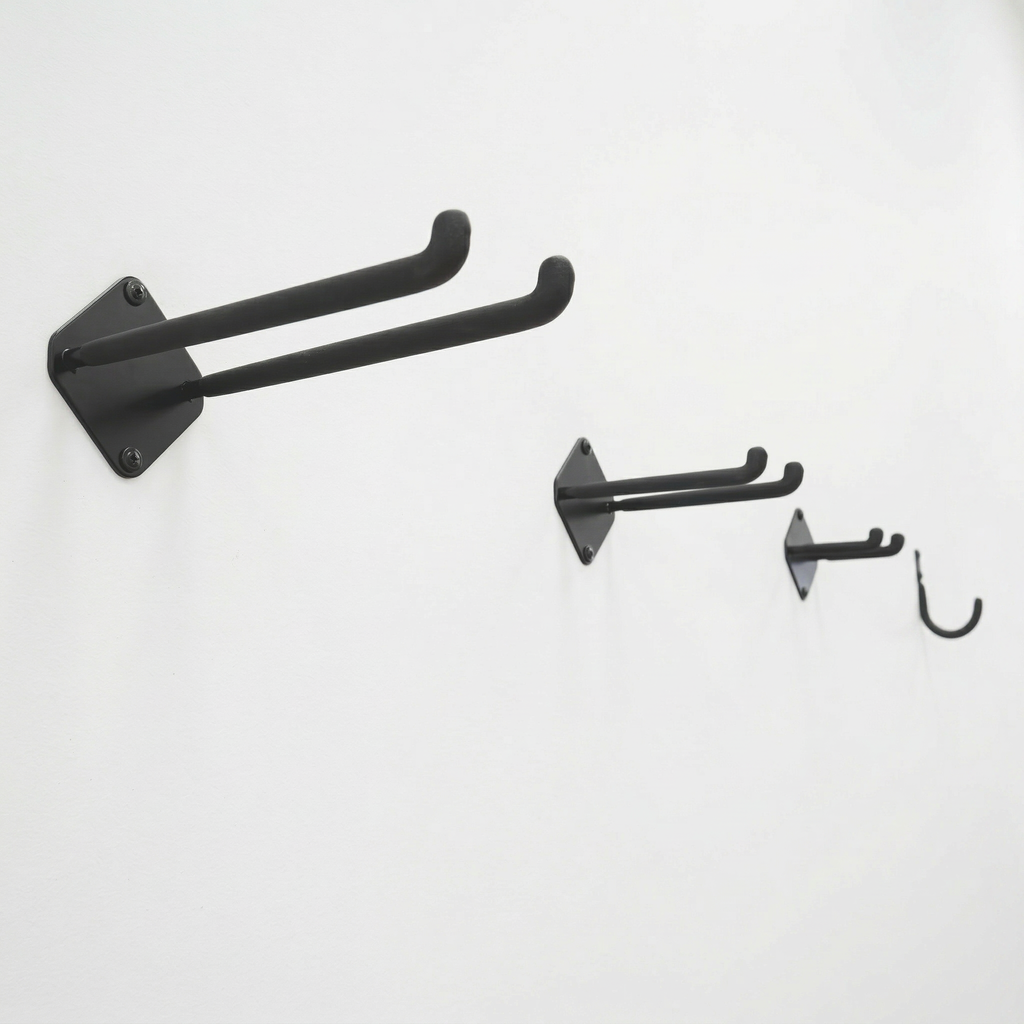 Large, medium and small double hooks and a mini J hook mounted on a wall