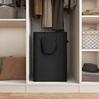 Black slim laundry hamper stored inside a closet