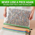 Large mesh zipper bag holding small building pieces with additional bags stacked below