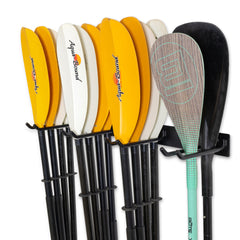 Kayak paddles and a SUP paddle stored on the Laurel Lake paddle rack