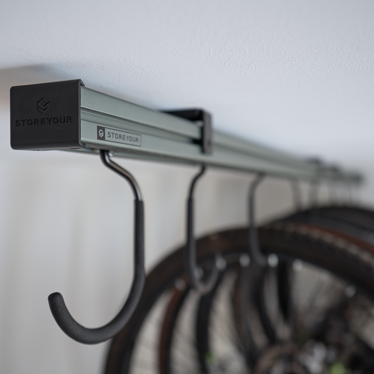 Close-up of the ceiling track and sliding bike hooks