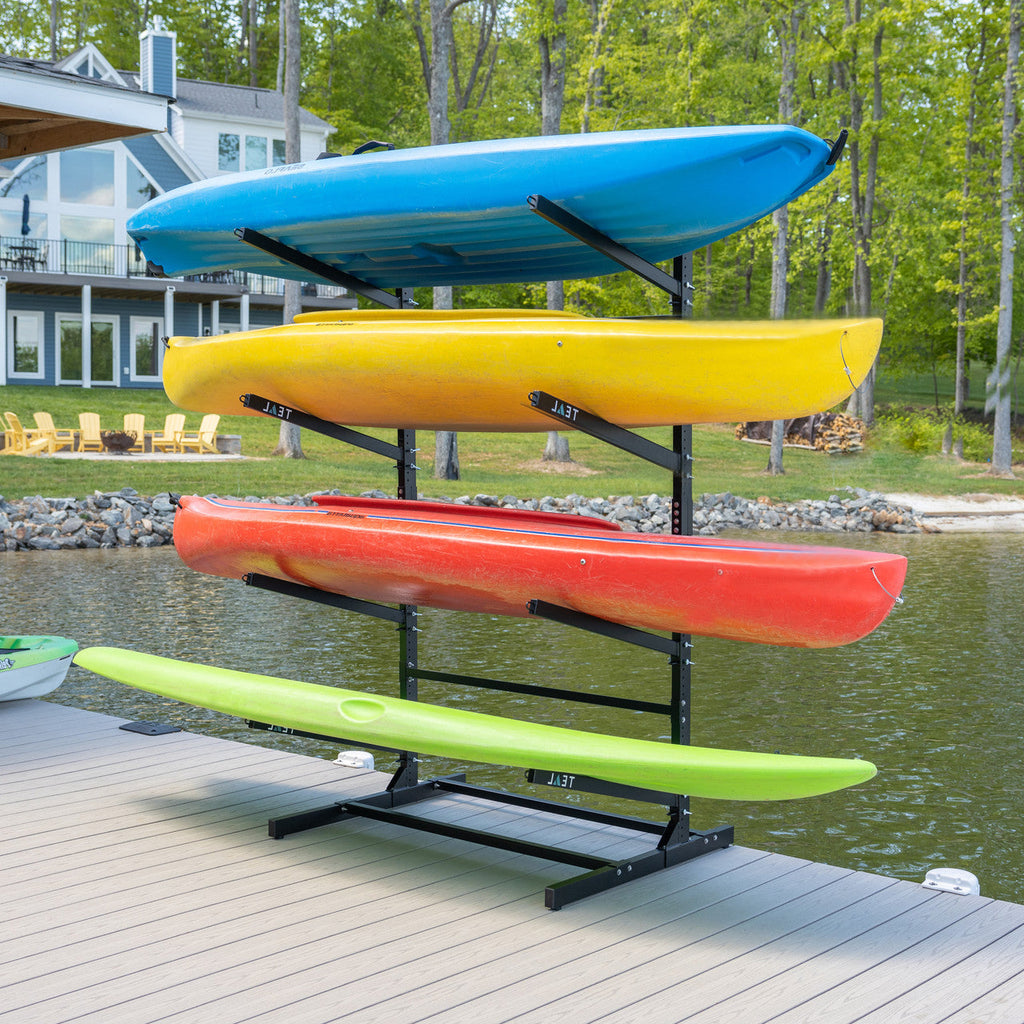 Four kayaks and a paddleboard on the freestanding 4-level rack on a dock