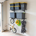 Black 1 x 4 ft wall shelves holding totes, with bikes and a cart hung below