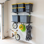 Black 1 x 4 ft wall shelves holding totes, with bikes and a cart hung below