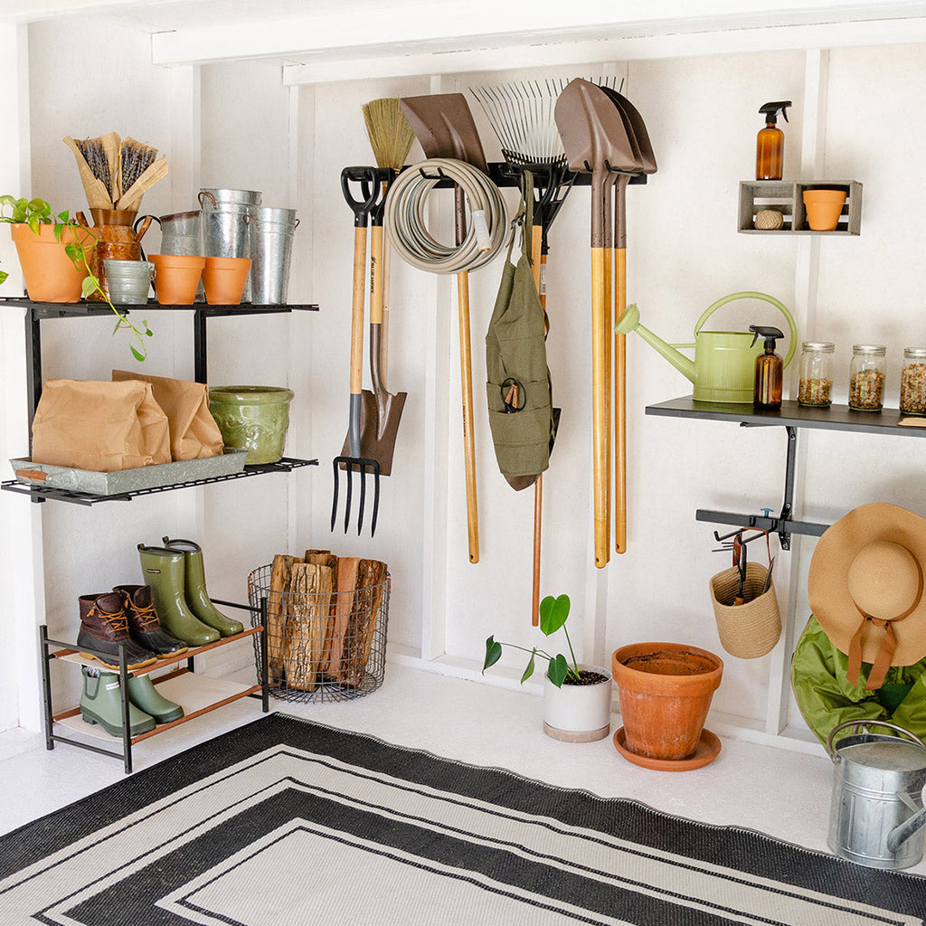 Shed with a garden tool organizer, shelves, plants and boots