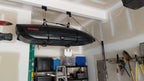 Cargo box stored near a garage ceiling on the hoist