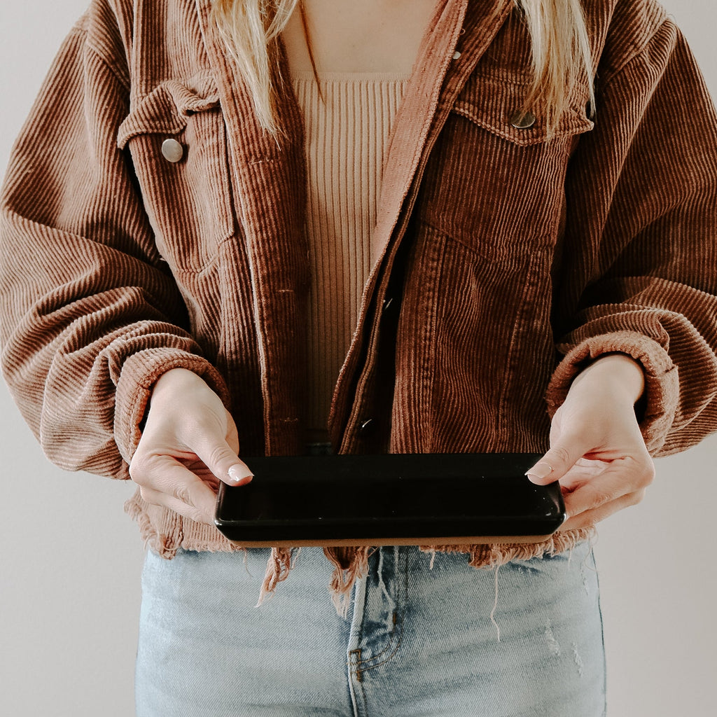Woman holding the matte black stoneware tray