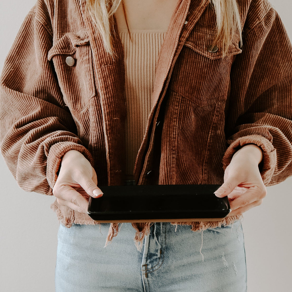 Woman holding the matte black stoneware tray