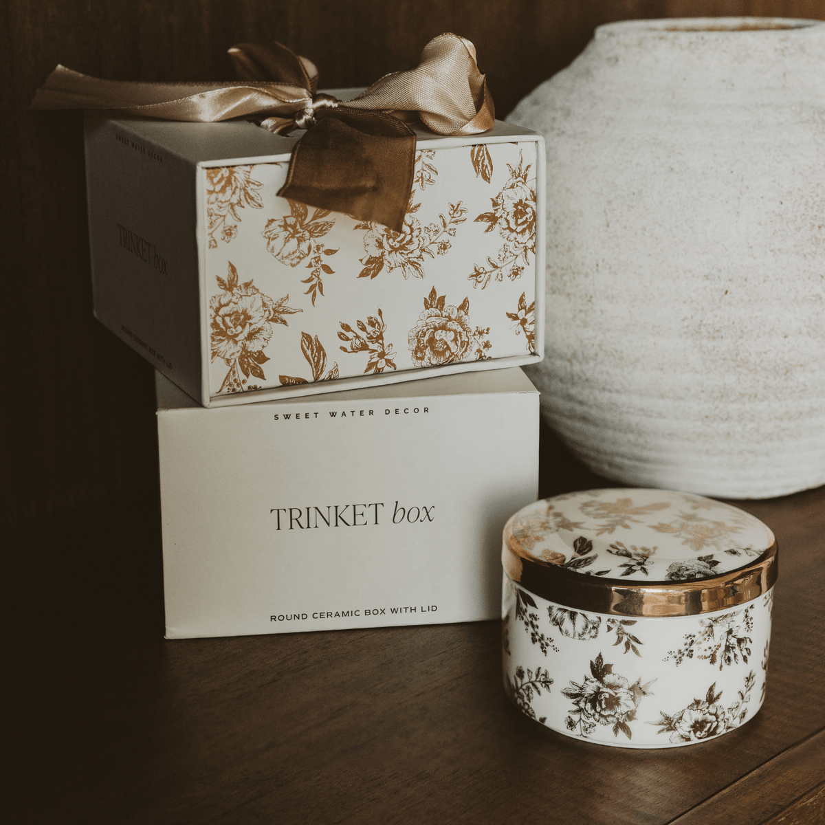 Gold Delft trinket box beside its gift box