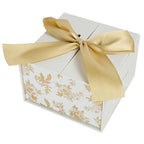 Gold Delft trinket box gift packaging tied with a gold ribbon