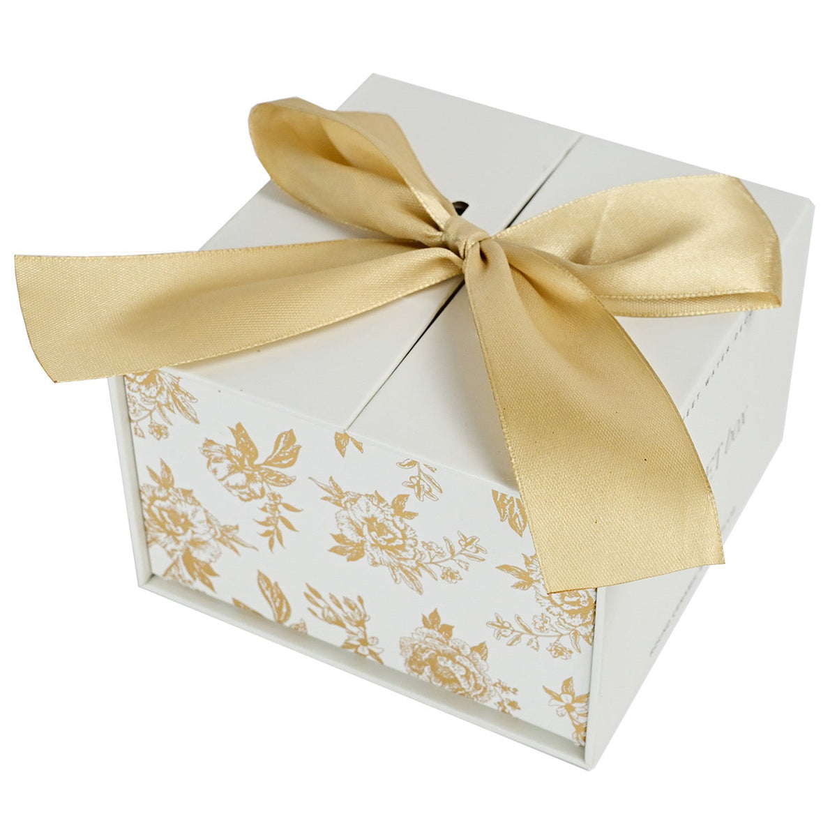 Gold Delft trinket box gift packaging tied with a gold ribbon