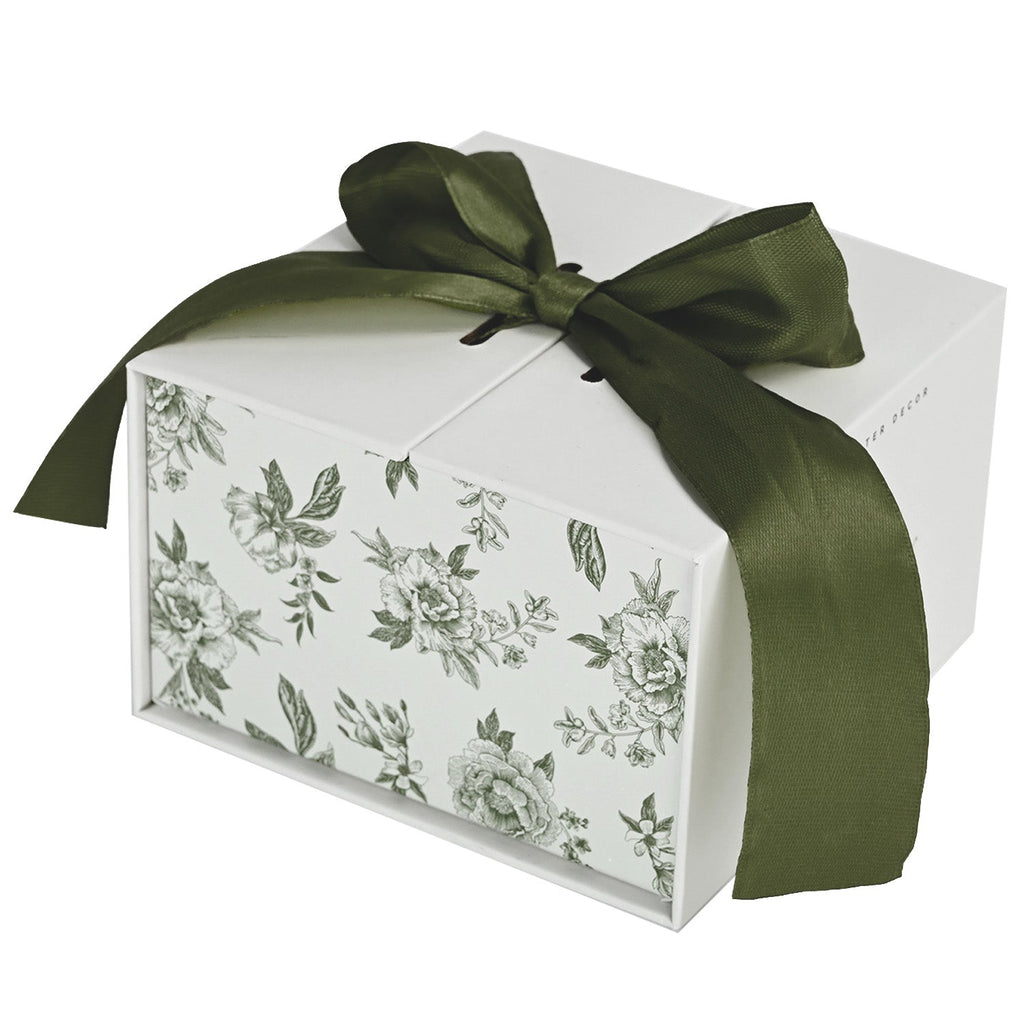 Green Delft trinket box gift packaging tied with a green ribbon