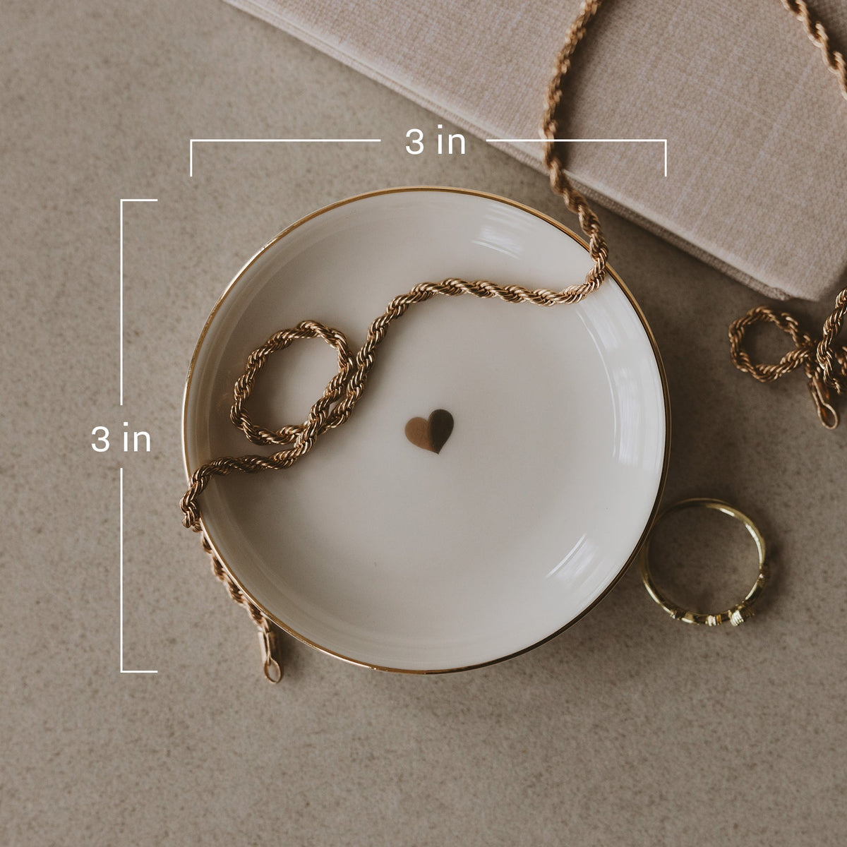 Gold heart jewelry dish with 3 x 3 inch dimensions marked
