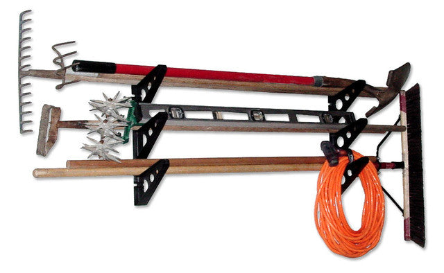 Rakes, a broom and an extension cord stored on the Trifecta racks
