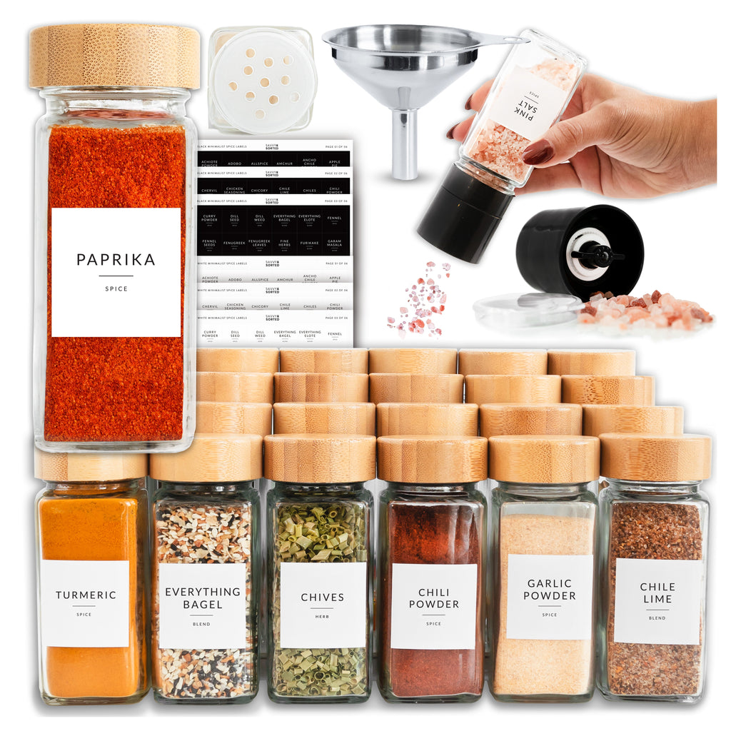 Paprika jar with bamboo lid beside the funnel, grinder, sifter lid and label sheets