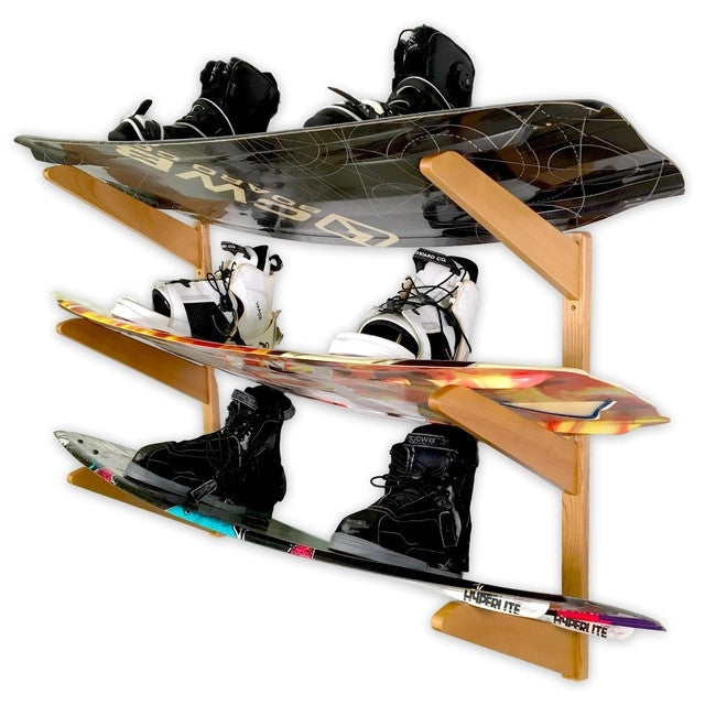 Three wakeboards with bindings stored on the TidyTimber 3-level wood wall rack
