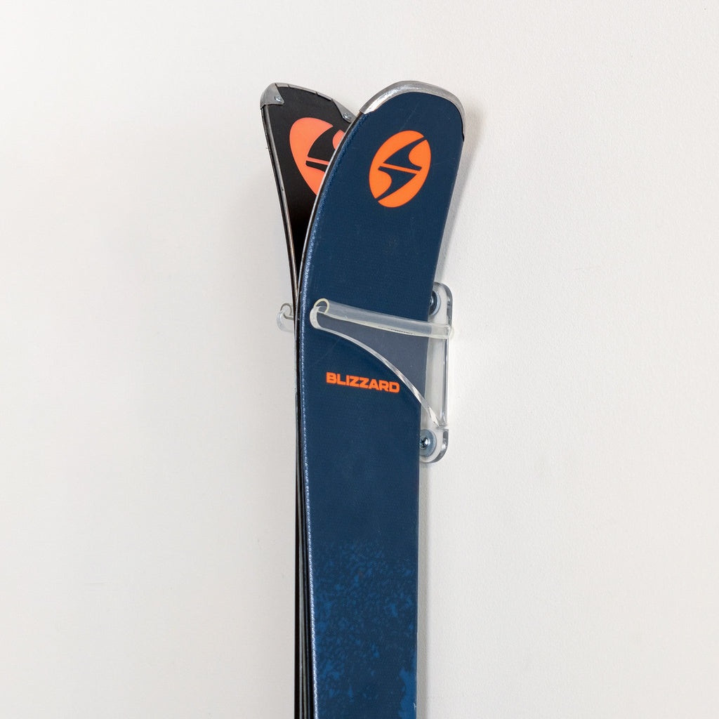 Close-up of ski tips held by the clear acrylic rack