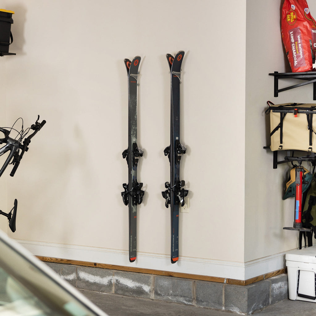Two pairs of skis stored on two clear Summit wall racks