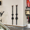 Two pairs of skis stored on two clear Summit wall racks