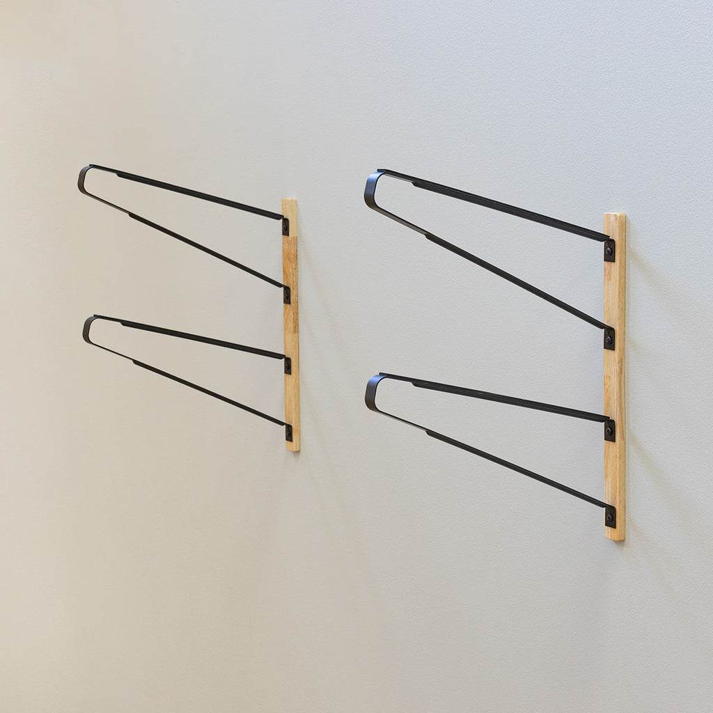Pair of empty 2-level surfboard wall racks with wood mounting boards