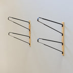 Pair of empty 2-level surfboard wall racks with wood mounting boards