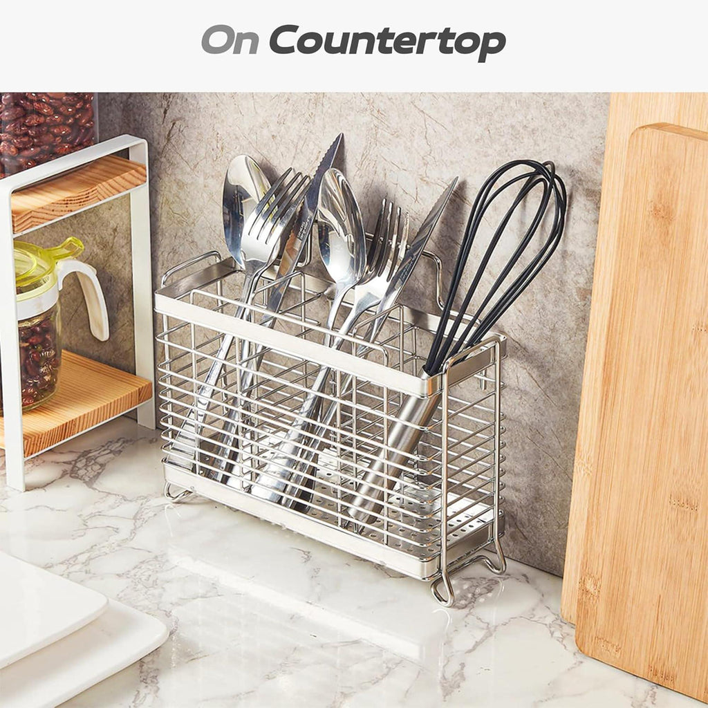 Three-compartment steel utensil organizer standing on a kitchen counter