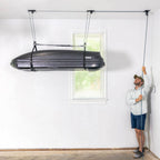 Man raising a rooftop cargo box to the ceiling with the EasyLift hoist