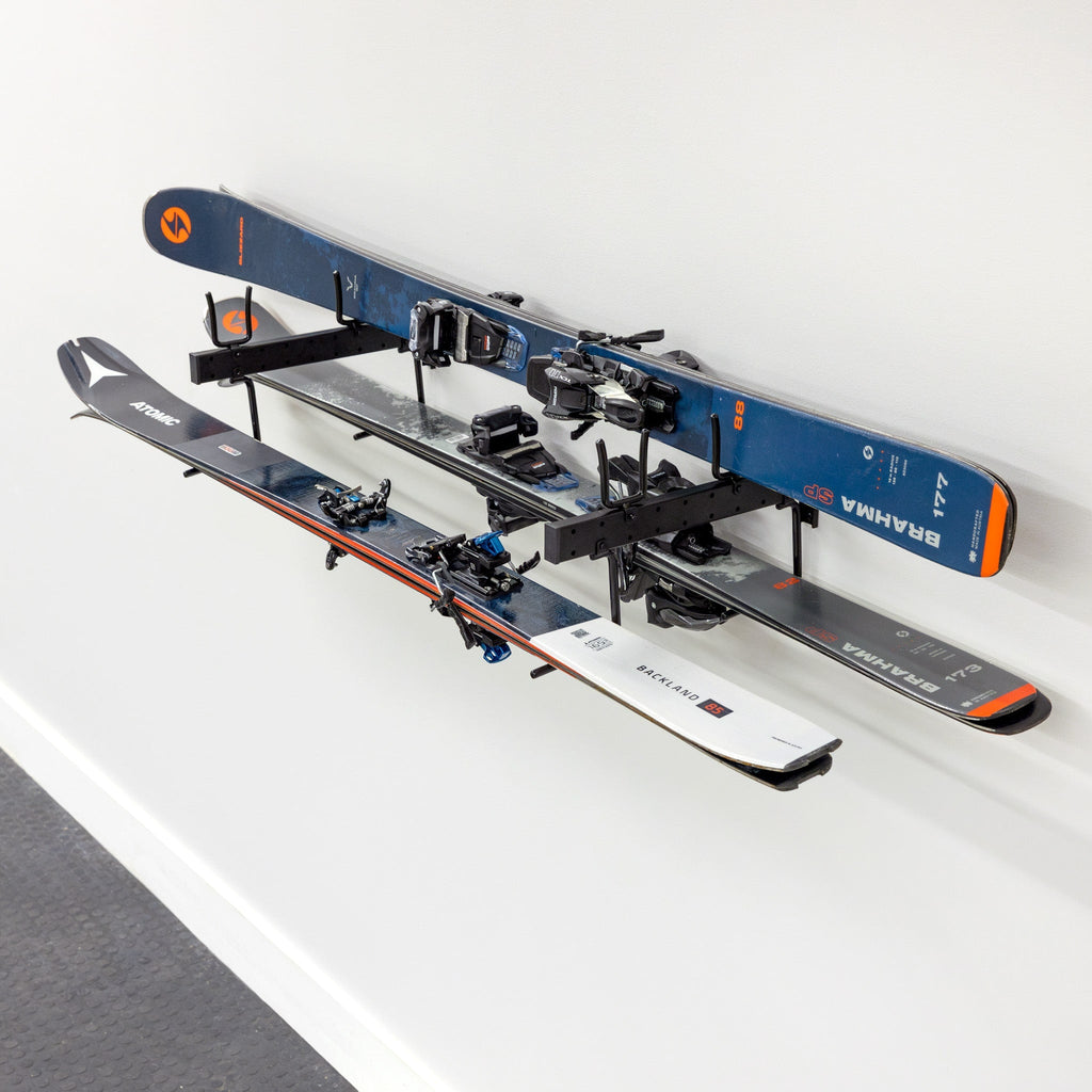 Skis and poles stored horizontally on the Cascade wall organizer