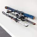 Skis and poles stored horizontally on the Cascade wall organizer