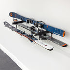 Skis and poles stored horizontally on the Cascade wall organizer