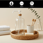 Clear 1 L pump bottle on a bathroom counter with towels and a toothbrush cup