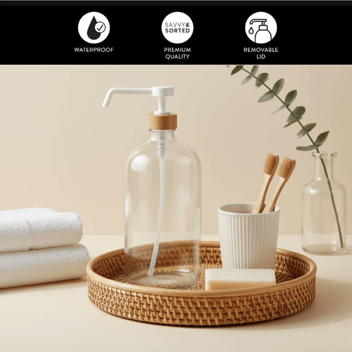 Clear 1 L pump bottle on a bathroom counter with towels and a toothbrush cup