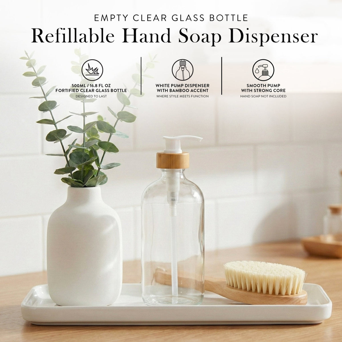 Refillable clear glass hand soap dispenser on a bathroom counter