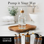 Clear glass bottle on a wooden tray with other pump bottles
