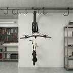 Single bike hanging from the ceiling track in a garage workshop