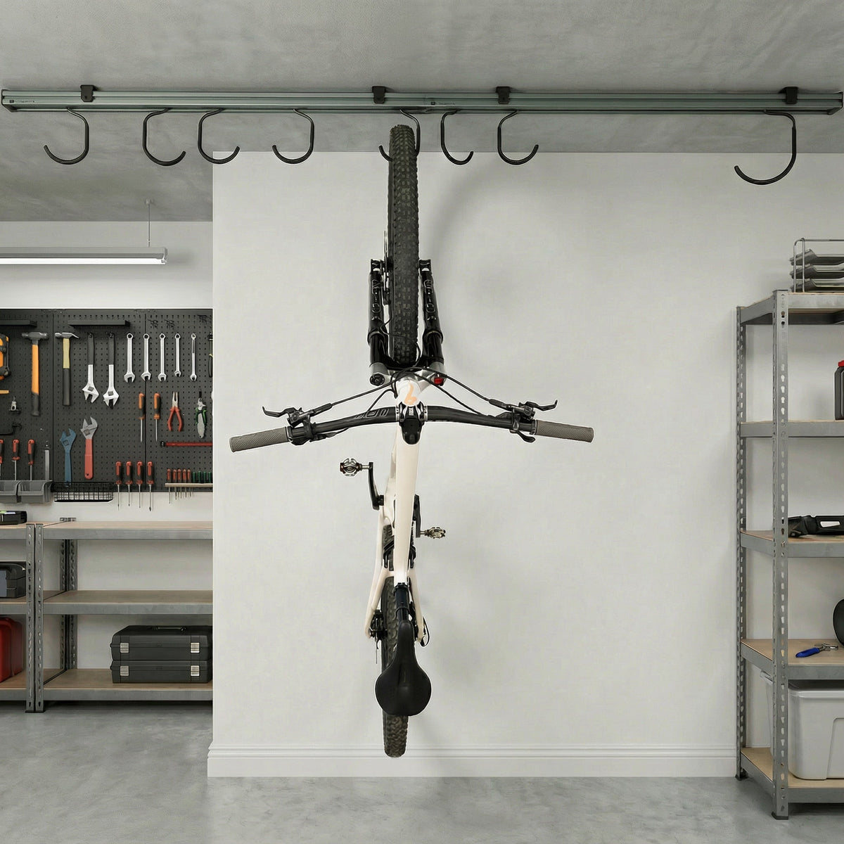Single bike hanging from the ceiling track in a garage workshop