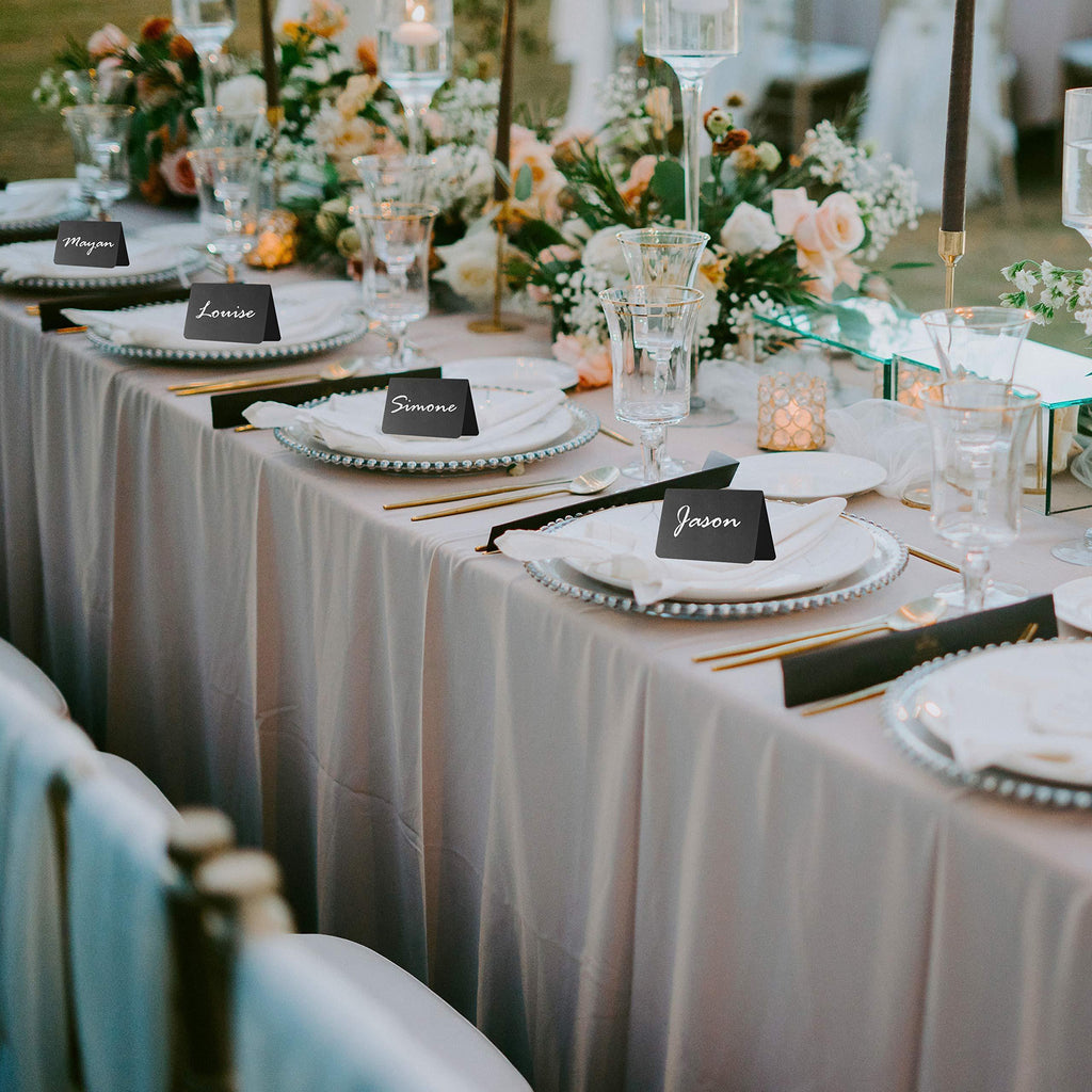 Black chalkboard tent signs used as place cards on a decorated table