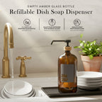 Refillable amber glass dish soap dispenser next to stacked plates