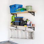 DIY brackets holding two wood shelves with bins and supplies, with a ladder hung below