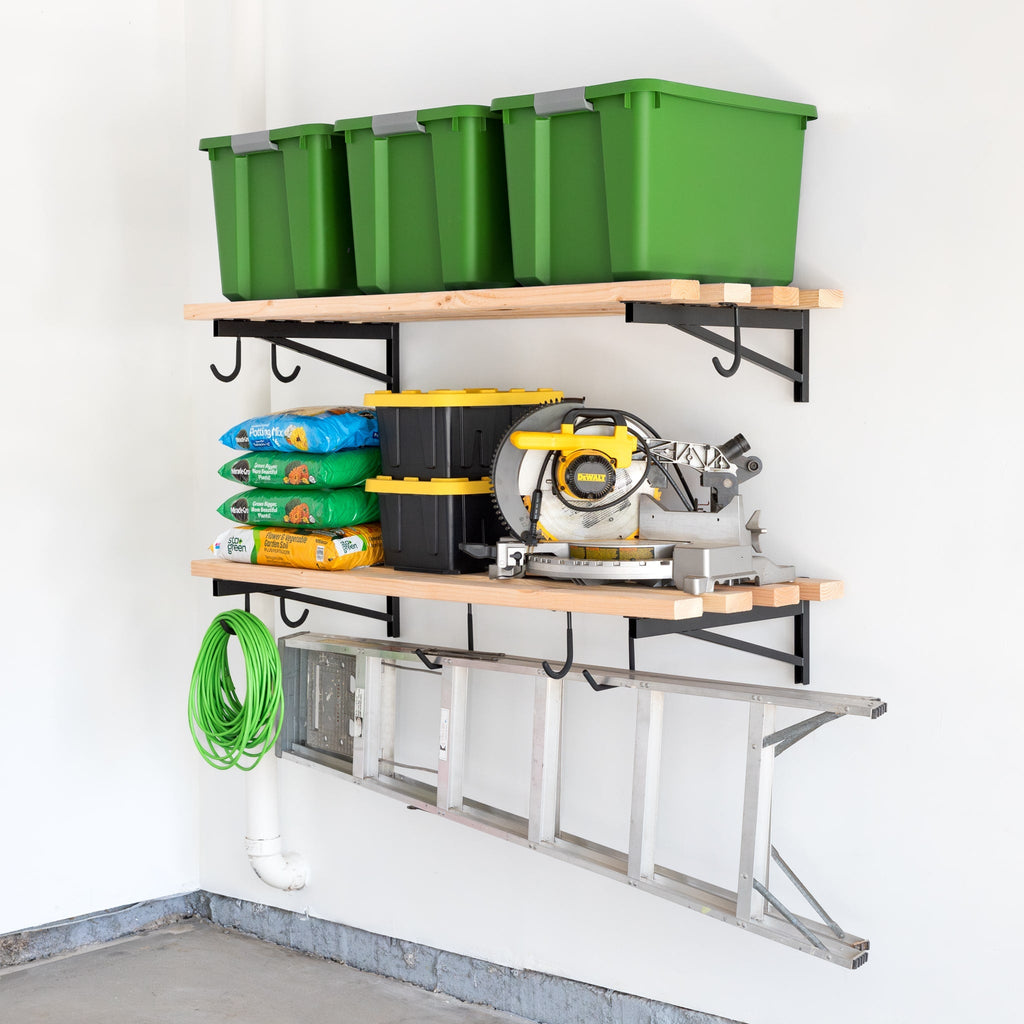 DIY brackets holding two 2 x 4 ft wood shelves with totes and a saw, with a ladder hung below