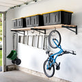 Long 2 x 8 ft wood shelf on three DIY brackets holding totes, with a bike and ladder hung below