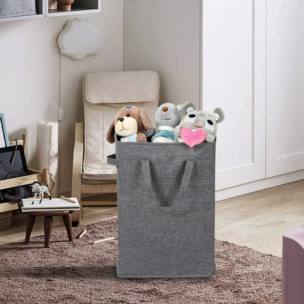 Dark gray laundry hamper holding soft toys beside a chair