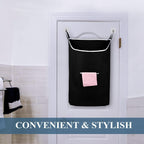 Black hanging laundry hamper installed behind a bathroom door