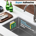 Adhesive sponge holder mounted inside a stainless steel kitchen sink, highlighting its self-adhesive support