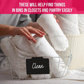 Black reusable clip-on label marked Clean on a wire basket of white towels