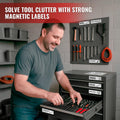 Man organizing a garage tool chest with white magnetic drawer labels