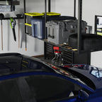 Overhead ceiling rack with storage bins above a parked car in a garage